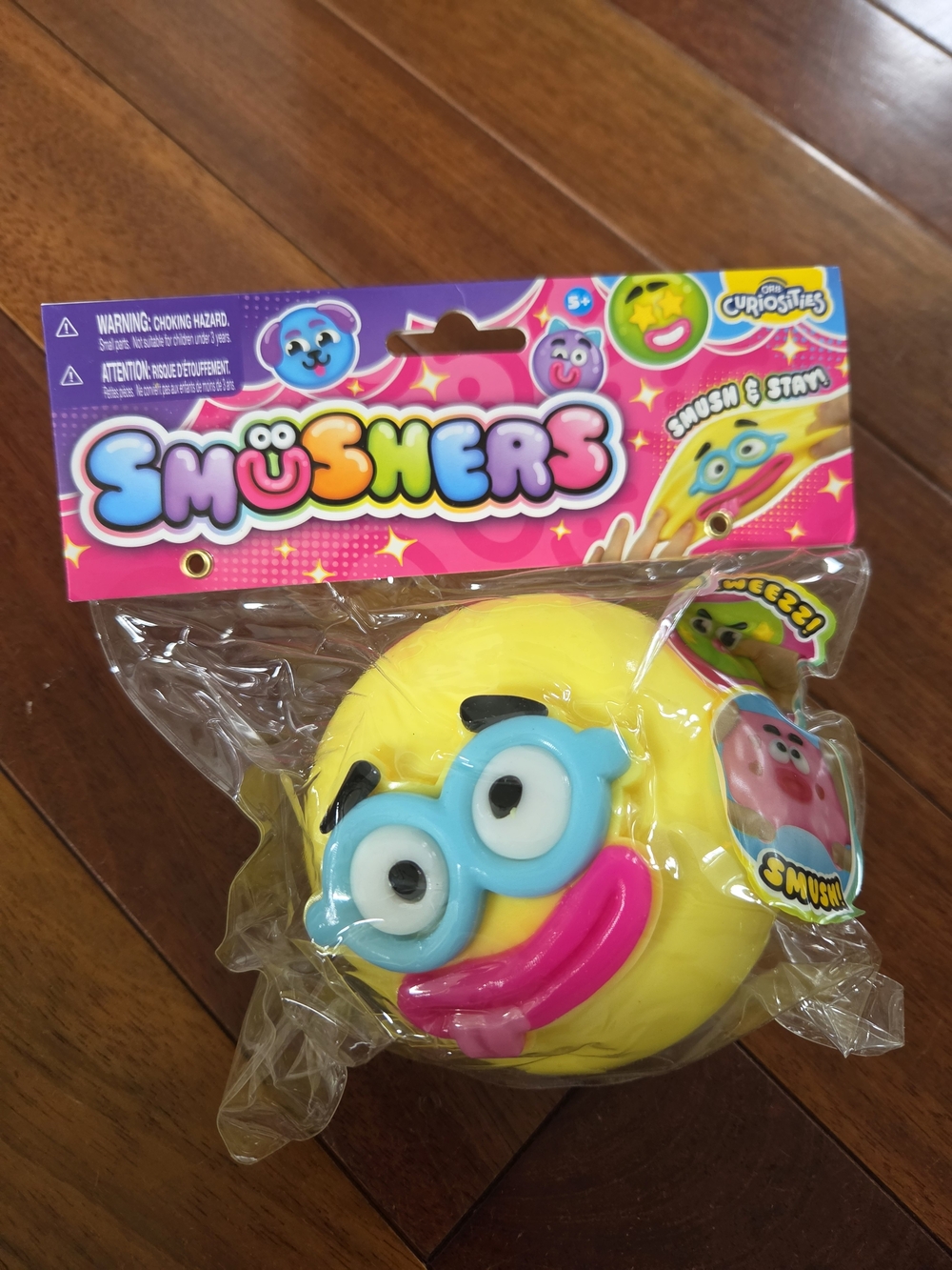 ORB Yellow Smusher Squishy Face Toy with Blue Goggles and Pink Mouth